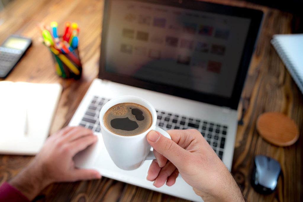 Man Working And Drinking Coffee In Office